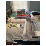 Large assortment of sewing items, including material, rulers and other items