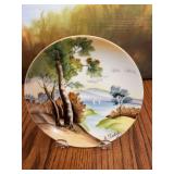 Vintage 6 inch hand painted porcelain decorative plate made in Japan featuring a painted landscape by artist A. Tuboy