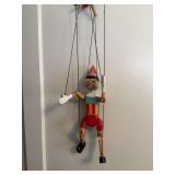 Vintage hand carved and hand-painted wooden Pinocchio marionette string puppet measuring approximately 26 inches long