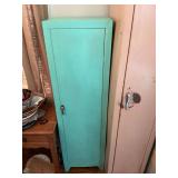 Antique Teal painted metal cabinet. 15” x 12 1/2” x 53” contents not included.