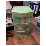 Green sterilite three drawer plastic organizer full of Christmas tags, boxes, ribbons, and tissue paper