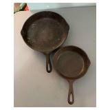 Vintage unmarked 11 three-quarter inch cast skillet and a Wagner wear 1055E skillet. These have been in the attic -need a good cleaning.