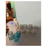 Assortment of ball jars and a Tupperware tea picture