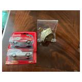 Vintage Coca-Cola brass wall mounted bottle opener with two Coca-Cola Corvette diecast cars