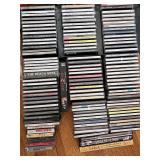 Various genres CDs, cassette tapes, VHS tape, and containers.