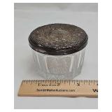 Powder jar with silver lid marked "weighted and reinforced 838".