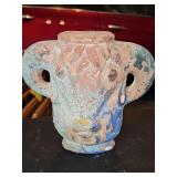 terracotta vessel featuring a distinctive weathered blue glaze with sculptural handles that resemble ancient pottery. 8.75 in tall.