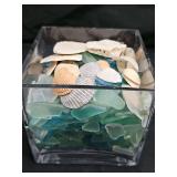 Square glass jar with sea glass and shells. 5 x 5 x 5.24 in tall.