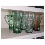 Six coca cola glasses. Two with handles.