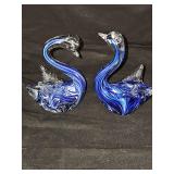 Two art glass swans with blue swirls. 5 1/8 and 5 1/2 in tall