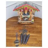 Black Forest chalet-style cuckoo clock from Germany.  Features set of rotating dancers on the upper stage and a seated accordion player on the right-hand bench. Tag in back indicates tune Roses du Sud