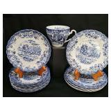 Johnson Brothers Coaching Scenes Blue ironstone plate featuring a blue-and-white transferware design of a horse-drawn carriage in the countryside with a floral scalloped border. Most have crazing. 1 c