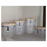 Four Felli Acrylic Storage Containers with embossed fruit. 4.5 - 8.75 in tall. Need washed.