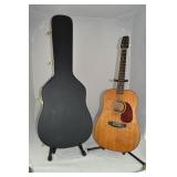 Vintage acoustic guitar with hard case, evidence o