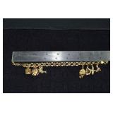 Marked 14 kt gold jewelry: charm bracelet with 7 c