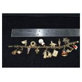 Marked 14 kt gold jewelry: charm bracelet with 15