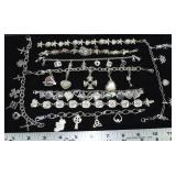 9 charm bracelets marked 925, 8.6ozt.; as is