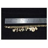 14 kt gold 7' charm bracelet with 9 charms mostly