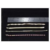 Four 14 kt gold bracelets: tennis bracelet missing