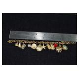 Marked 14 kt gold jewelry: charm bracelet with 13