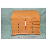 Oak finish 7 drawer jewelry cabinet with hinged li