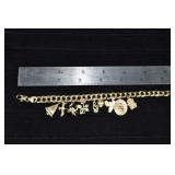 14 kt gold 7" charm bracelet with 9 charms mostly