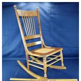 Oak spindle back and cane seat rocking chair; as i