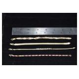 Four 14 kt gold bracelets: tennis bracelet missing