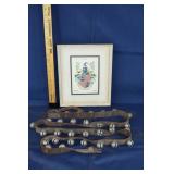 Framed coat of arms and a length of sleigh bells;