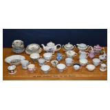 Collection of porcelain tea cups, saucers, pots, p