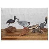 4 shore birds on driftwood stands by John & Patric