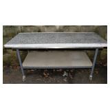 Steel table on wheels mounted with granite counter