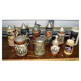 10 German style ceramic steins and tankards; as is