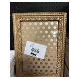 2 gold colored pictured frames