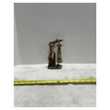 Figurine of Deer Holding Upside Down Hunter