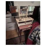Bed, side table with mirror, pictures