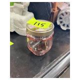 Pink jar with lid and jewelry