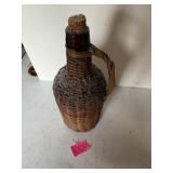 Vintage glass jug with wicker trim