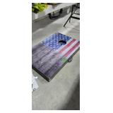 Cornhole boards located under table