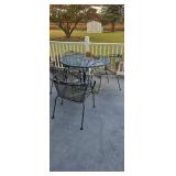 Metal Patio Table And Four Chairs Located On