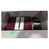 Set of world book encyclopedias under table