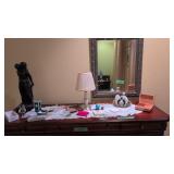 Items On Top Of Dresser Perfume Lamp And Statue