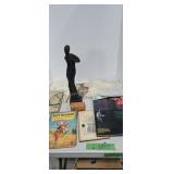 Books wooden statue fence charger under table