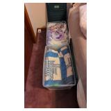 Quilts and blankets in 2 plastic tubs