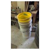 Plastic buckets rollers and clamps on floor