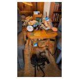 Binoculars camera alarm clock items on table as