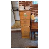 Four drawer oak file cabinet and mirror on Wall