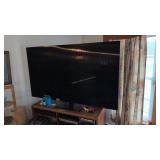 Samsung 75 inch flat screen TV with wooden stand