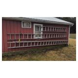 Three large aluminum extension ladders