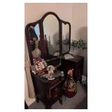 Vintage tri-fold mirrored vanity and items on top